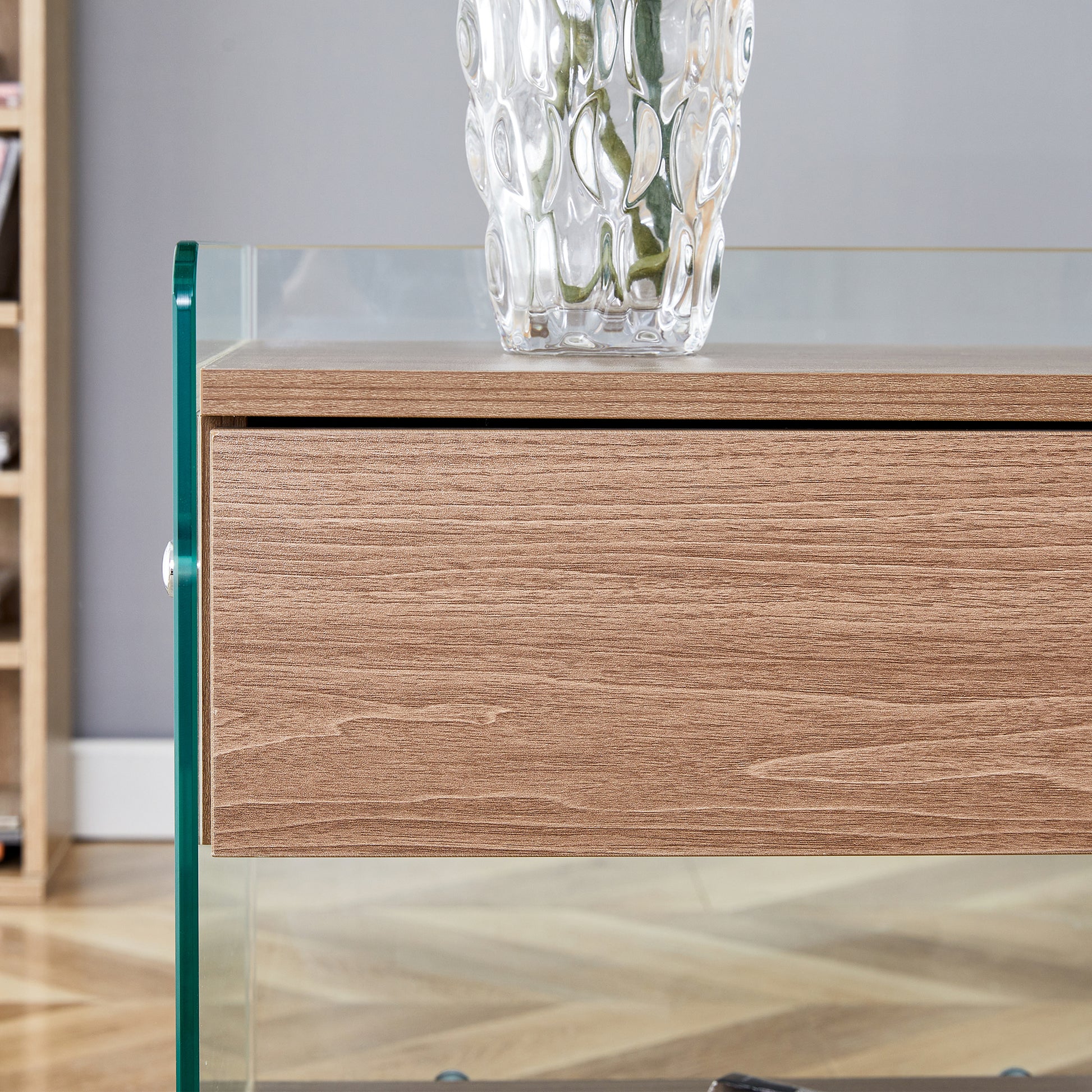 Bedside table with drawers. The board surface is MDF sticker, and both sides are transparent tempered glass. The design is simple and elegant, with excellent storage functions.