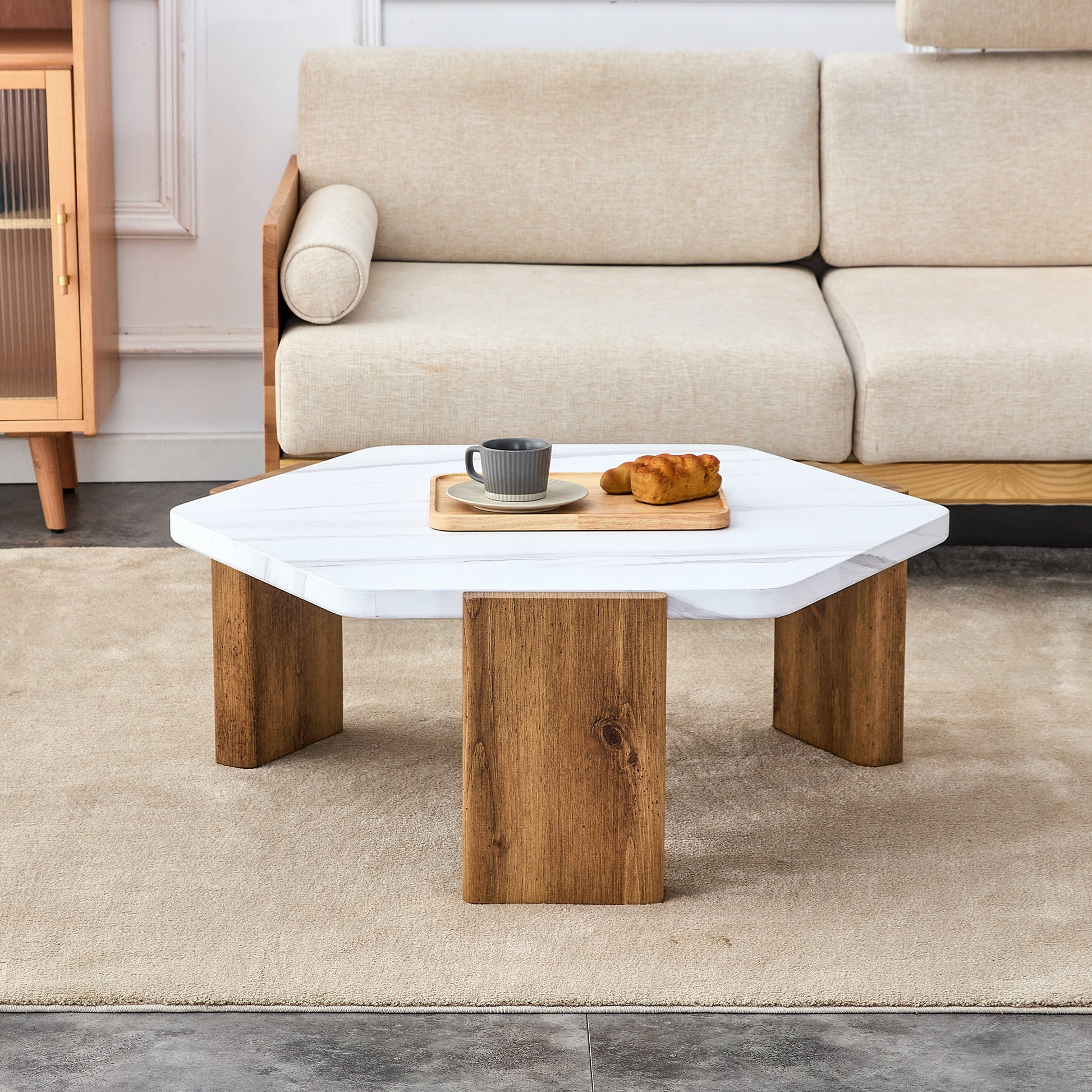 Modern practical MDF coffee table with white tabletop and wooden toned legs. Suitable for living rooms and guest rooms.