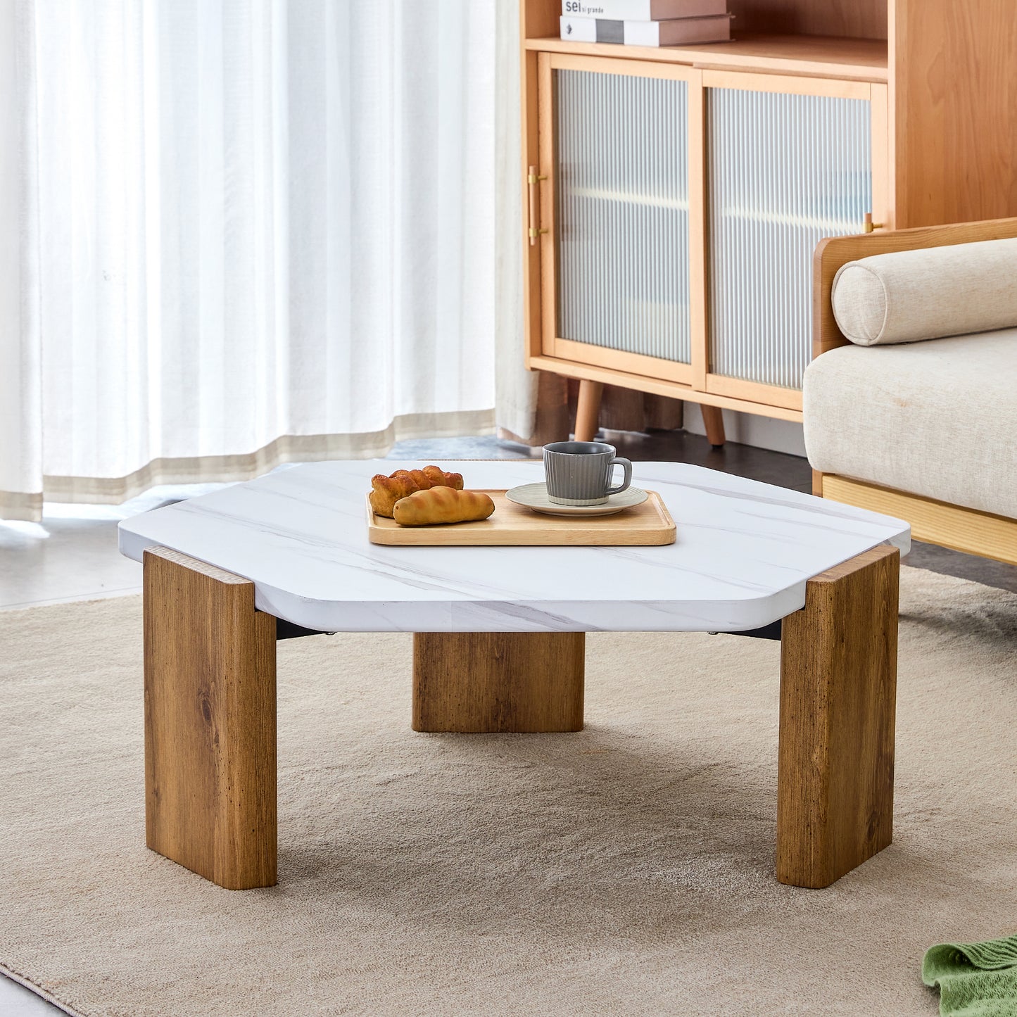 Modern practical MDF coffee table with white tabletop and wooden toned legs. Suitable for living rooms and guest rooms.