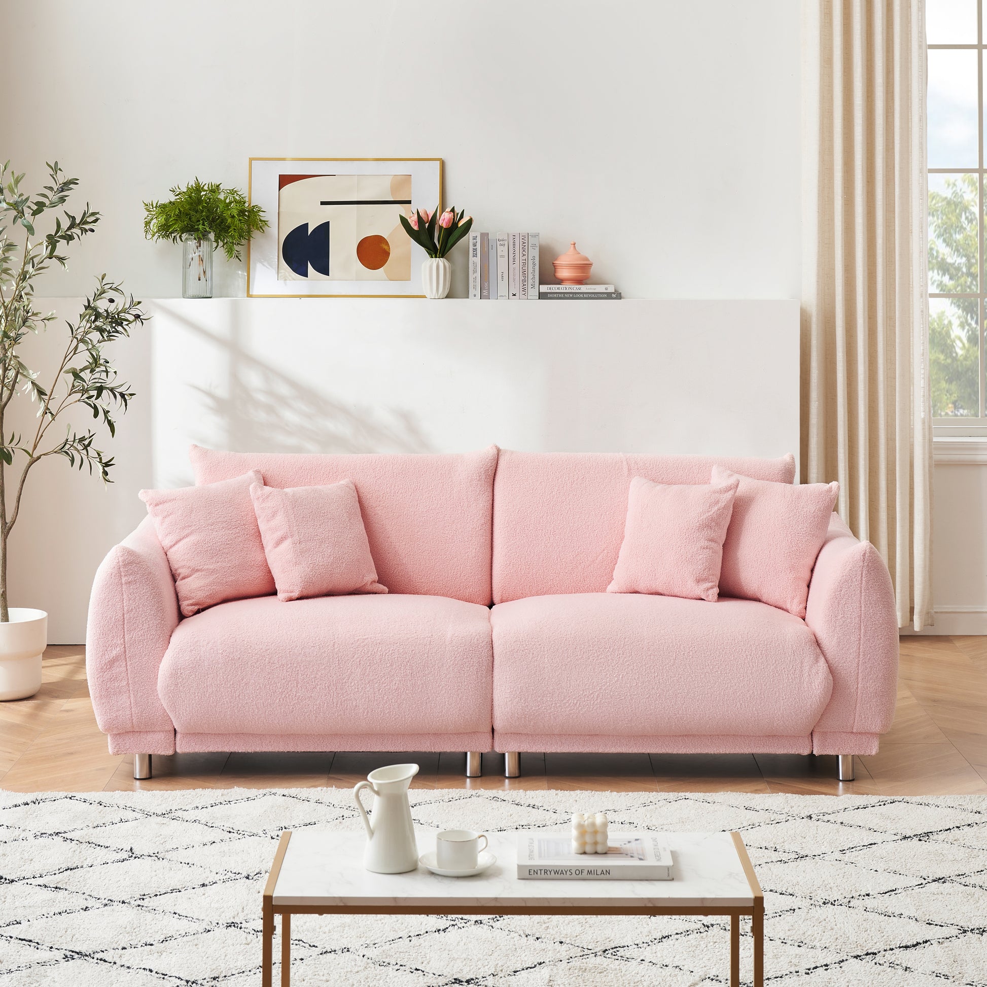 The 86.6 inch teddy fleece pink sofa with four throw pillows and hardware feet can sit comfortably in an apartment bedroom without taking up space